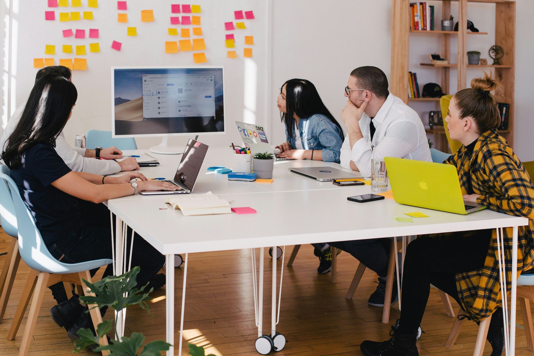group of at a local business working on a project around a conference table