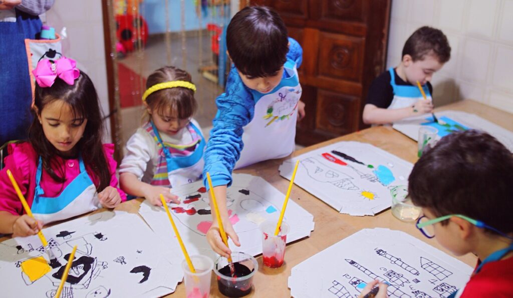 children doing arts and crafts indoors around a table